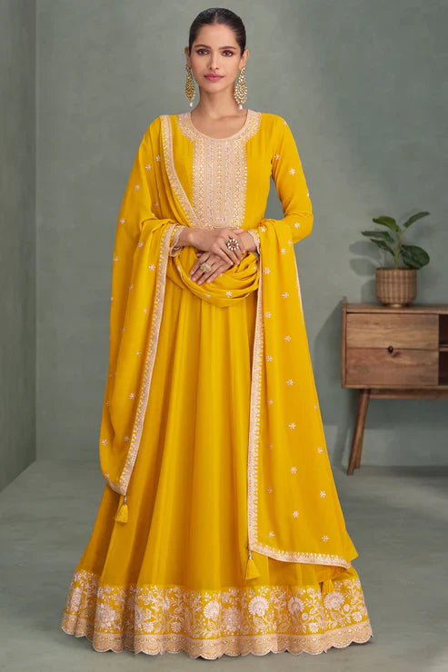 Woman wearing a yellow traditional outfit with a gray background